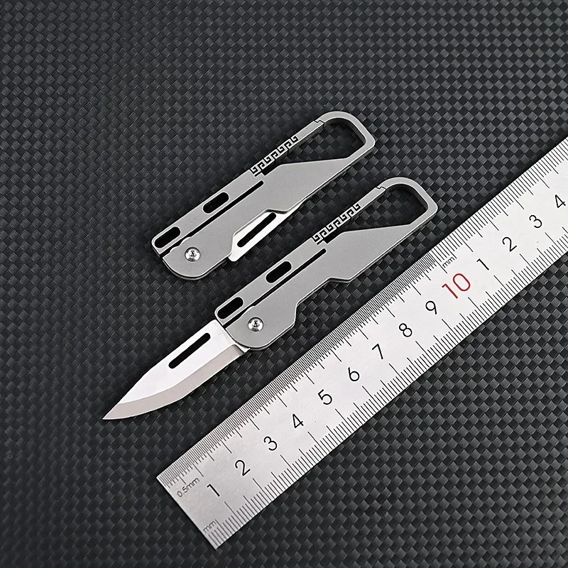 Cuchillo de bolsillo de aleación de titanio, multiherramienta de supervivencia para acampar, Mini cuchillo plegable, herramientas EDC para exteriores, llavero de cubo, cortador de Unboxing
