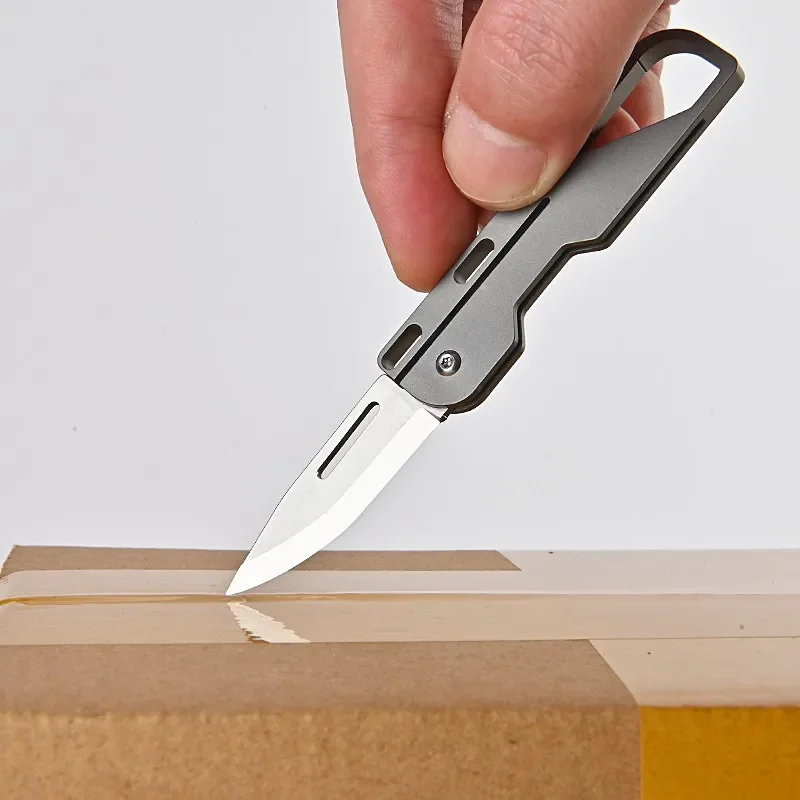 Cuchillo de bolsillo de aleación de titanio, multiherramienta de supervivencia para acampar, Mini cuchillo plegable, herramientas EDC para exteriores, llavero de cubo, cortador de Unboxing